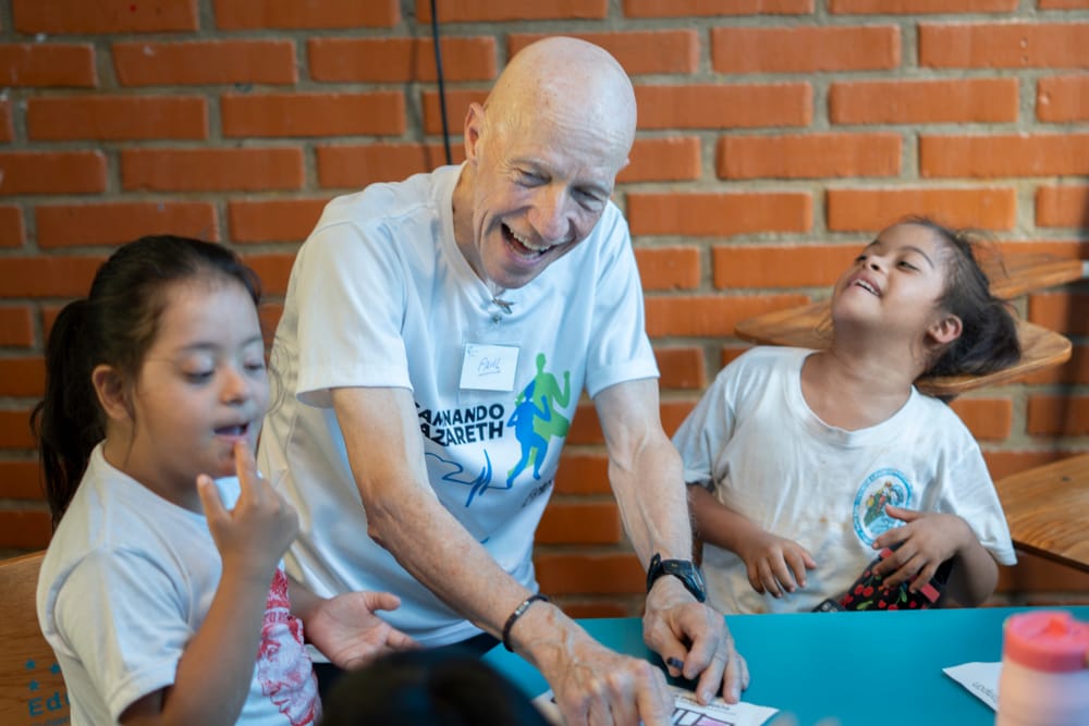 american with two students with special needs in a Nazareth School at Olancho Honduras